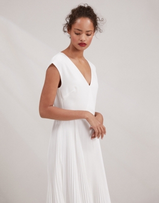 white dress with pleated skirt